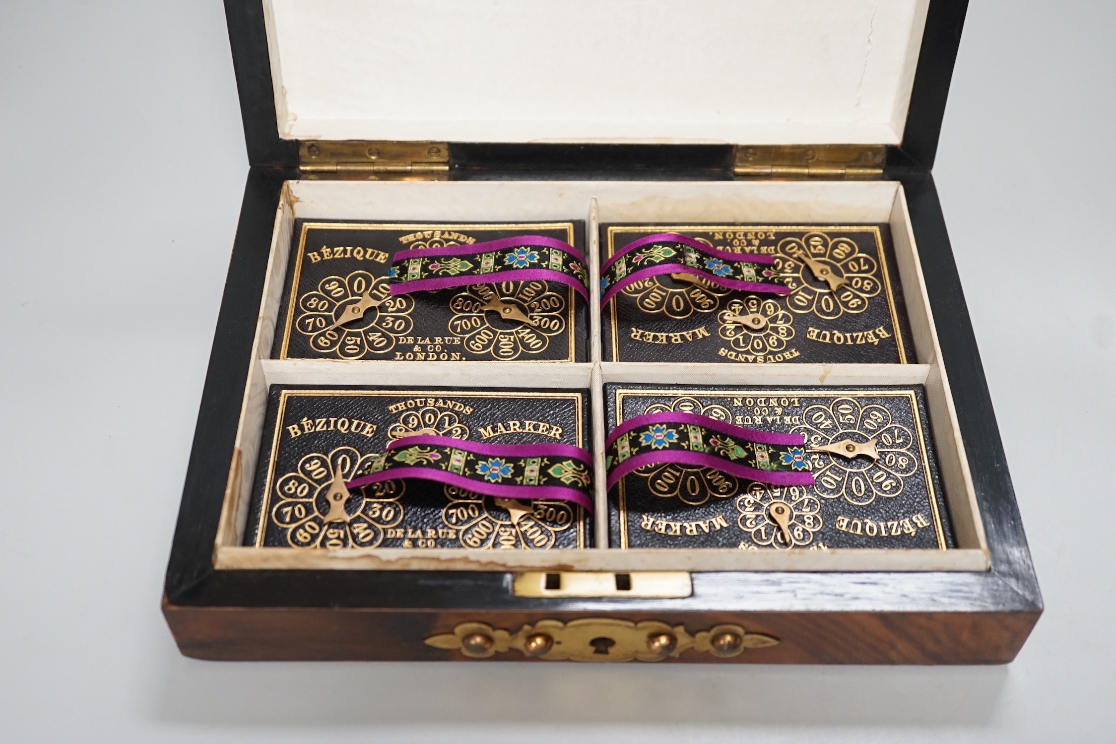 A Victorian walnut and brass 'Bezique' games box and a rosewood box. Largest 23cm wide